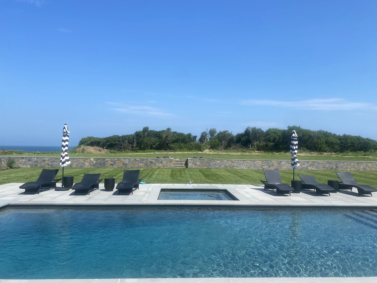Oceanfront Nantucket property landscaped by Ryan Conway Landscaping — pool, spa, bluestone patio and manicured lawn